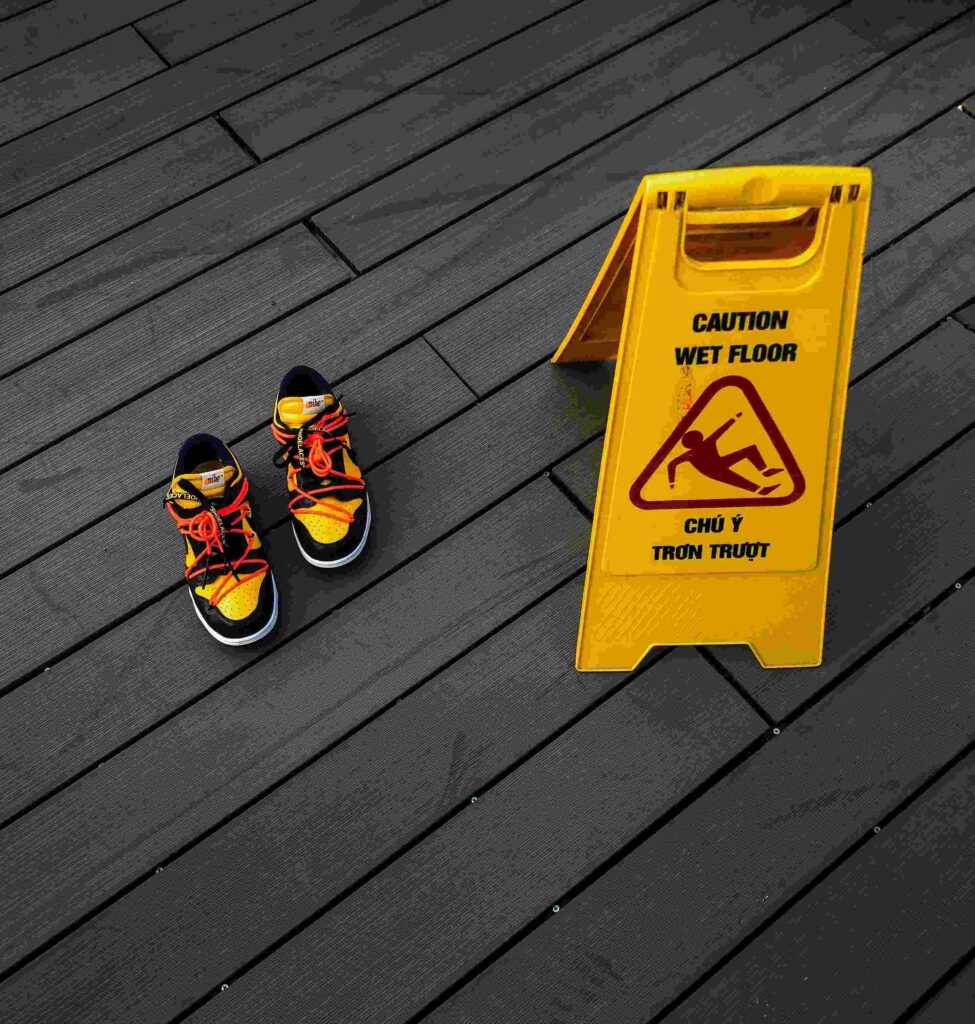 pair of trainers next to a sign saying "caution wet floor" to show the idea will life insurance cover accidental death